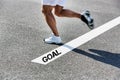 Man stepping on white line with goal sign