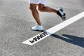 Man stepping on white line with winner sign