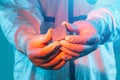 A man in sterile form holds a microprocessor, close-up. Microchip production technology, modern production, special microcircuit.