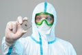 A man in sterile form holds a microprocessor in his hands, close-up. Microchip Design Technology, Advanced Manufacturing, Special