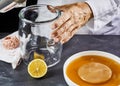 Man sterilising a glass container to make kombucha