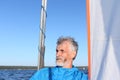 Man sternly looking away amid sail and sky Royalty Free Stock Photo