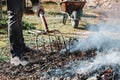 man stiring the bonfire in an orchard