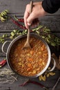 Man stirring a lentil stew