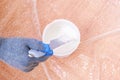 A man stirs white acrylic paint with special plastic stirrer. Painting the door. Royalty Free Stock Photo