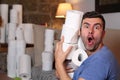 Man stocking up toilet paper at home