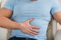 Man With Stomach Ache Sitting On Couch Royalty Free Stock Photo