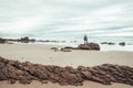 Man in stones at Oyambre beach in Cantabria, north of Spain Royalty Free Stock Photo