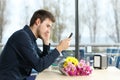 Man stood up in a date checking phone messages Royalty Free Stock Photo