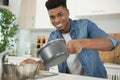 Man straining food through collander