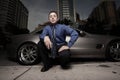 Man on the street with his luxury sports car Royalty Free Stock Photo