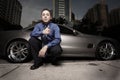 Man on the street with his luxury sports car Royalty Free Stock Photo