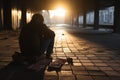 A man in streets shadow beseeches for help and money, representing homelessness Royalty Free Stock Photo