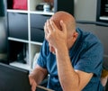 Man stressed while working from home on laptop Royalty Free Stock Photo