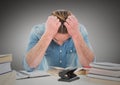 Man stressed at desk against grey background