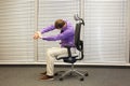 Man stretching arms,exercising on chair Royalty Free Stock Photo