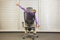 man stretching arms sitting on chair in office Royalty Free Stock Photo