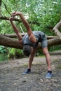 Man stretching body and feeling flexible while exercising at the forest Royalty Free Stock Photo