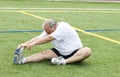 Man stretching exercising field Royalty Free Stock Photo