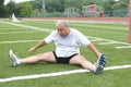 man stretching exercising sports field Royalty Free Stock Photo