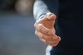Man stretching hand for handshake outdoors, closeup Royalty Free Stock Photo