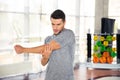 Man stretching hands at gym