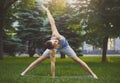 Man stretching hands and legs in park. Royalty Free Stock Photo