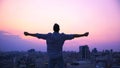 Man stretching hands on roof edge, enjoying freedom, believe in future success Royalty Free Stock Photo