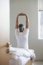 Man Stretching Hands While Sitting On Edge Of Bed Royalty Free Stock Photo