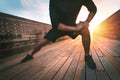 Man stretching leg adductor muscles and warming up for training outdoors