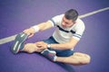 Man stretching leg on the running track Royalty Free Stock Photo