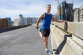Man, stretching legs and running in city, warm up for cardio workout and fitness outdoor. Athlete, sports and runner in