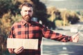 Man with strict face and beard travelling by hitchhiking