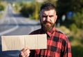 Man with strict face and beard travelling by hitchhiking