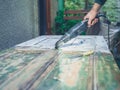 Man stripping paint with heat gun Royalty Free Stock Photo