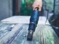 Man stripping paint with heat gun