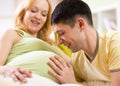 Man strokes belly of his pregnant woman. Careful Royalty Free Stock Photo