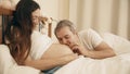 Man stroking pregnant wife`s belly and talking to baby Royalty Free Stock Photo