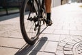 Man with strong legs riding sport bike on city street Royalty Free Stock Photo