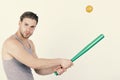 Man with strong muscles on white background. Player with concentrated face plays baseball. Royalty Free Stock Photo