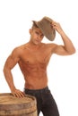 Man strong no shirt barrel putting on hat Royalty Free Stock Photo