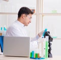 Man student working in chemical lab on experiment Royalty Free Stock Photo