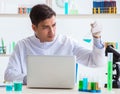 Man student working in chemical lab on experiment Royalty Free Stock Photo