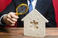 Man studies the missing piece in puzzles house. Purchase or construction comfortable dream home. Mortgage loan purchase real Royalty Free Stock Photo