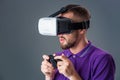 Man in studio wearing virtual reality headset playing game Royalty Free Stock Photo