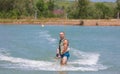 Man study wakeboarding on a blue lake Royalty Free Stock Photo