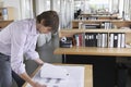 Man Studying Blueprint In Office Royalty Free Stock Photo