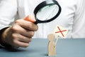 A man is studying a protester through a magnifying glass. Figure of a man with a protest poster. study of protests and action Royalty Free Stock Photo