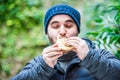 Man stuffing his face with a hamburger and feeling nice Royalty Free Stock Photo