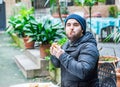 Man stuffing his face with a hamburger and feeling nice - side view